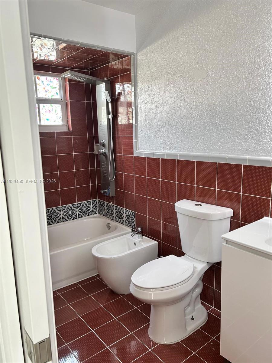 948 East 47th Street, Unit 948A Hialeah, FL 33013 - Photo 10 of 14 a bathroom with a toilet a sink and bathtub