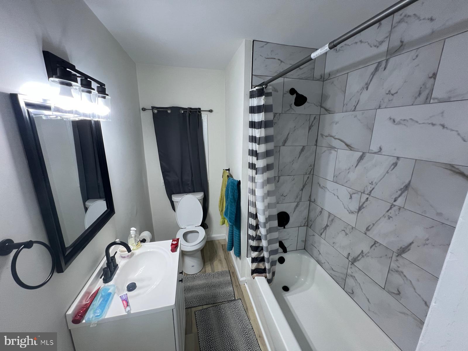3711 10th Street Baltimore, MD 21225 - Photo 13 of 25 a bathroom with a tub sink and mirror