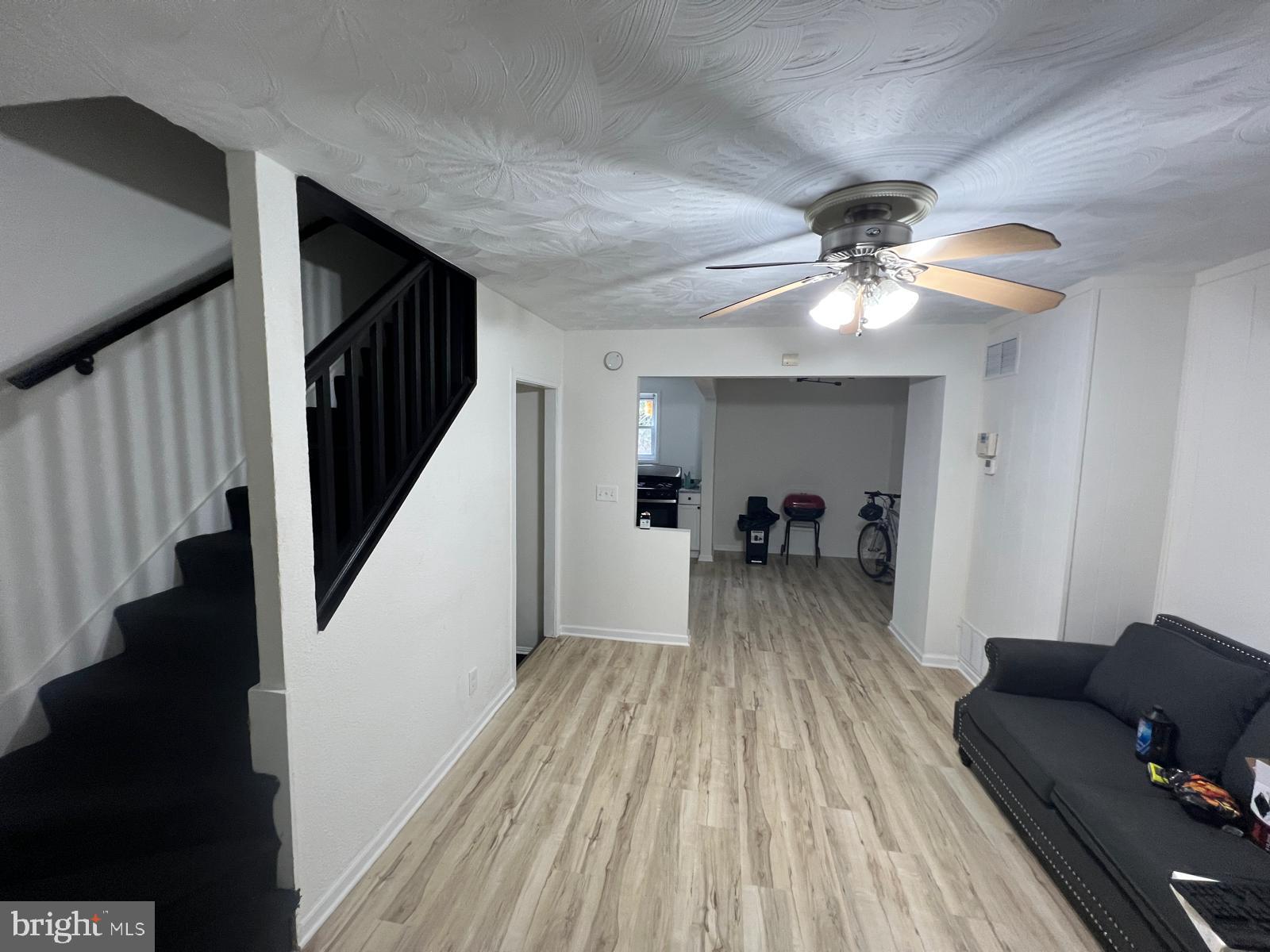 3711 10th Street Baltimore, MD 21225 - Photo 4 of 25 a view of a livingroom with furniture and a ceiling fan