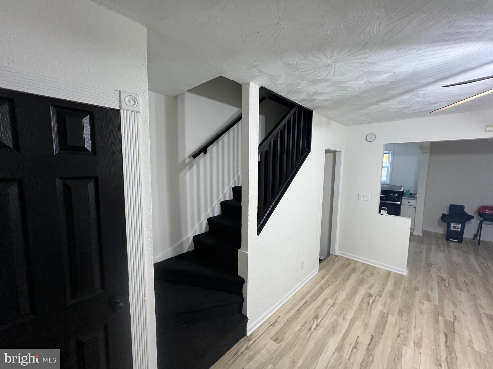 3711 10th Street Baltimore, MD 21225 - Photo 5 of 25 a view of entryway and hall with wooden floor