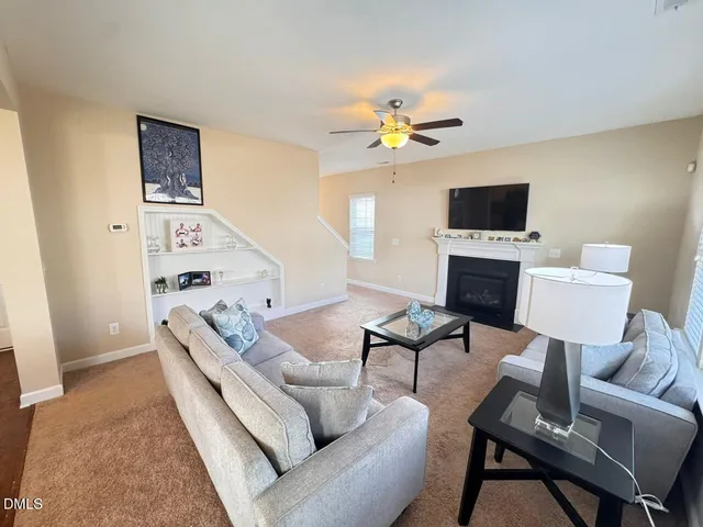 a living room with furniture a rug and a flat screen tv