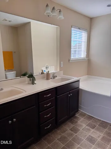 a bathroom with a sink double vanity and a mirror