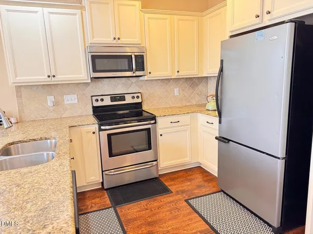 a kitchen with a refrigerator stove and microwave