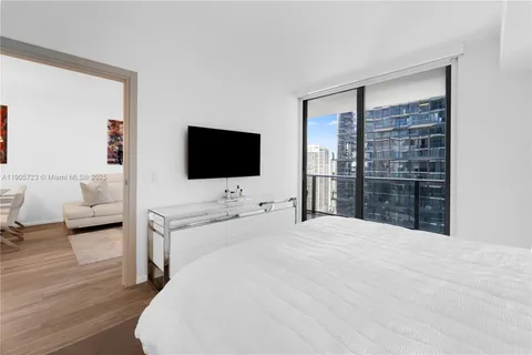 a large bedroom with a flat tv and a bed