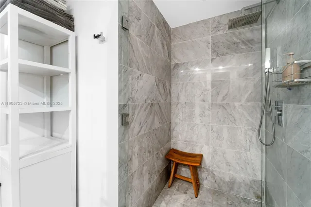 a bathroom with a shower and a vanity