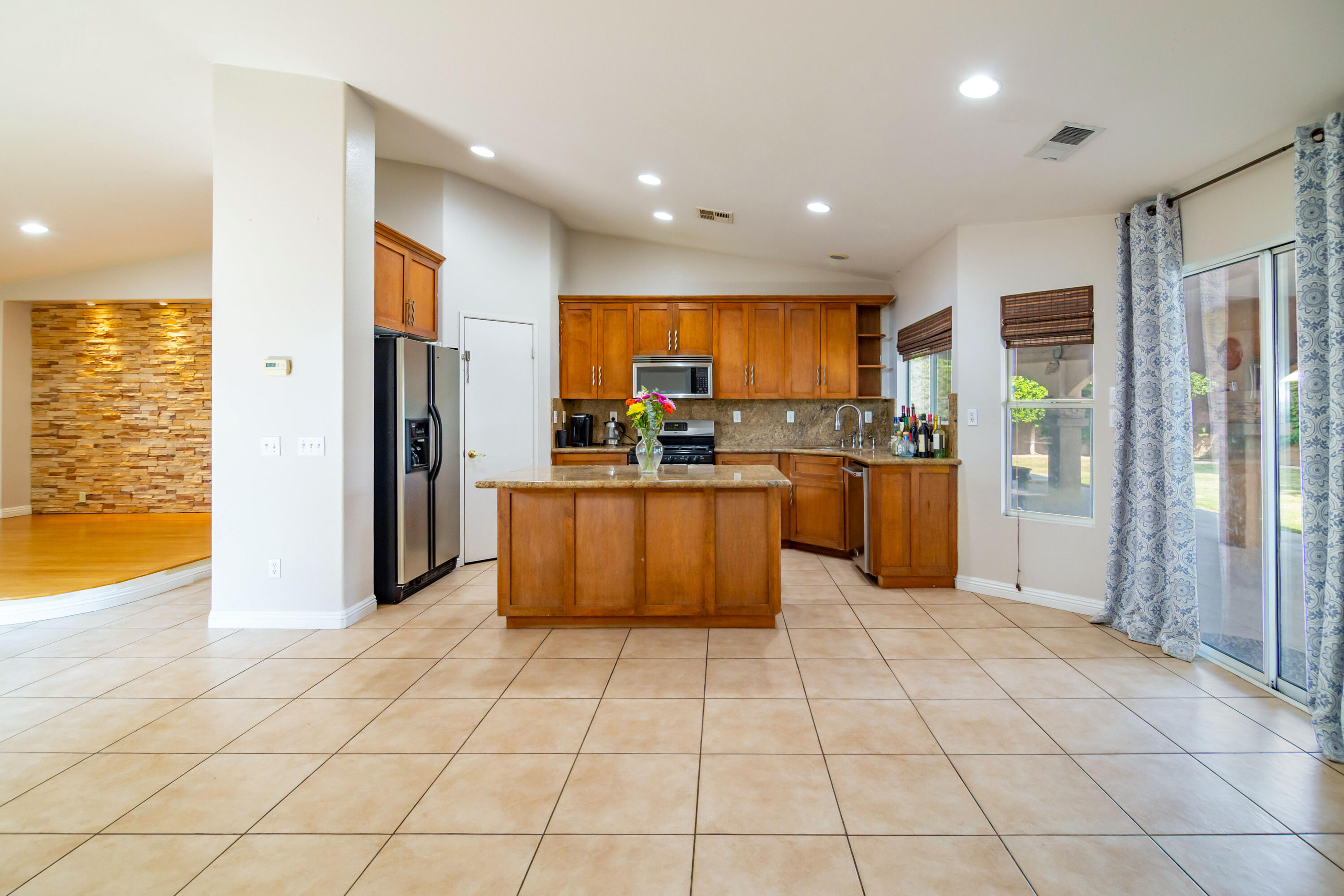 83290 Antigua Drive Indio, CA 92201 - Photo 11 of 31 a kitchen with stainless steel appliances granite countertop a refrigerator and a stove top oven