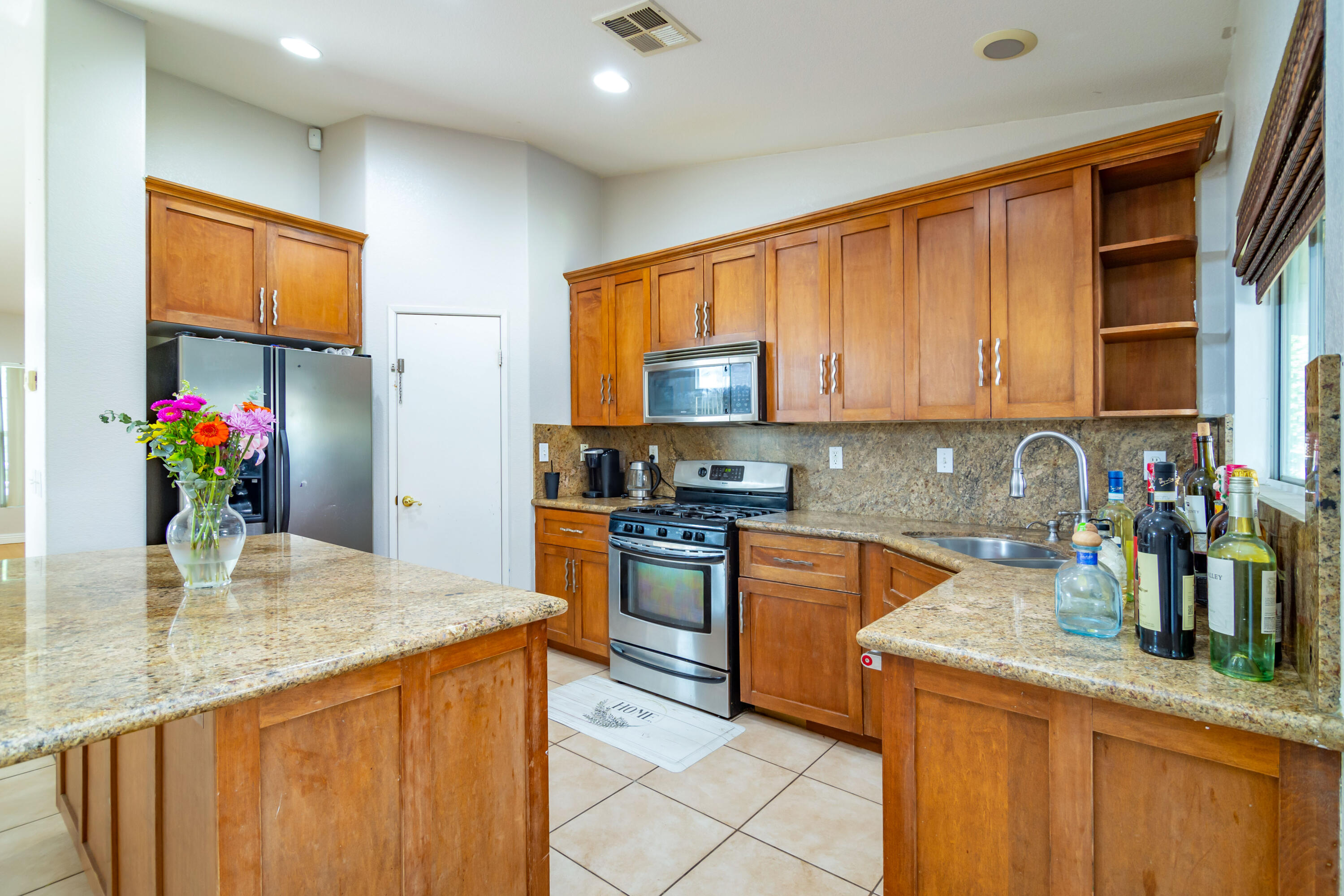 83290 Antigua Drive Indio, CA 92201 - Photo 14 of 31 a kitchen with stainless steel appliances granite countertop a sink refrigerator and cabinets