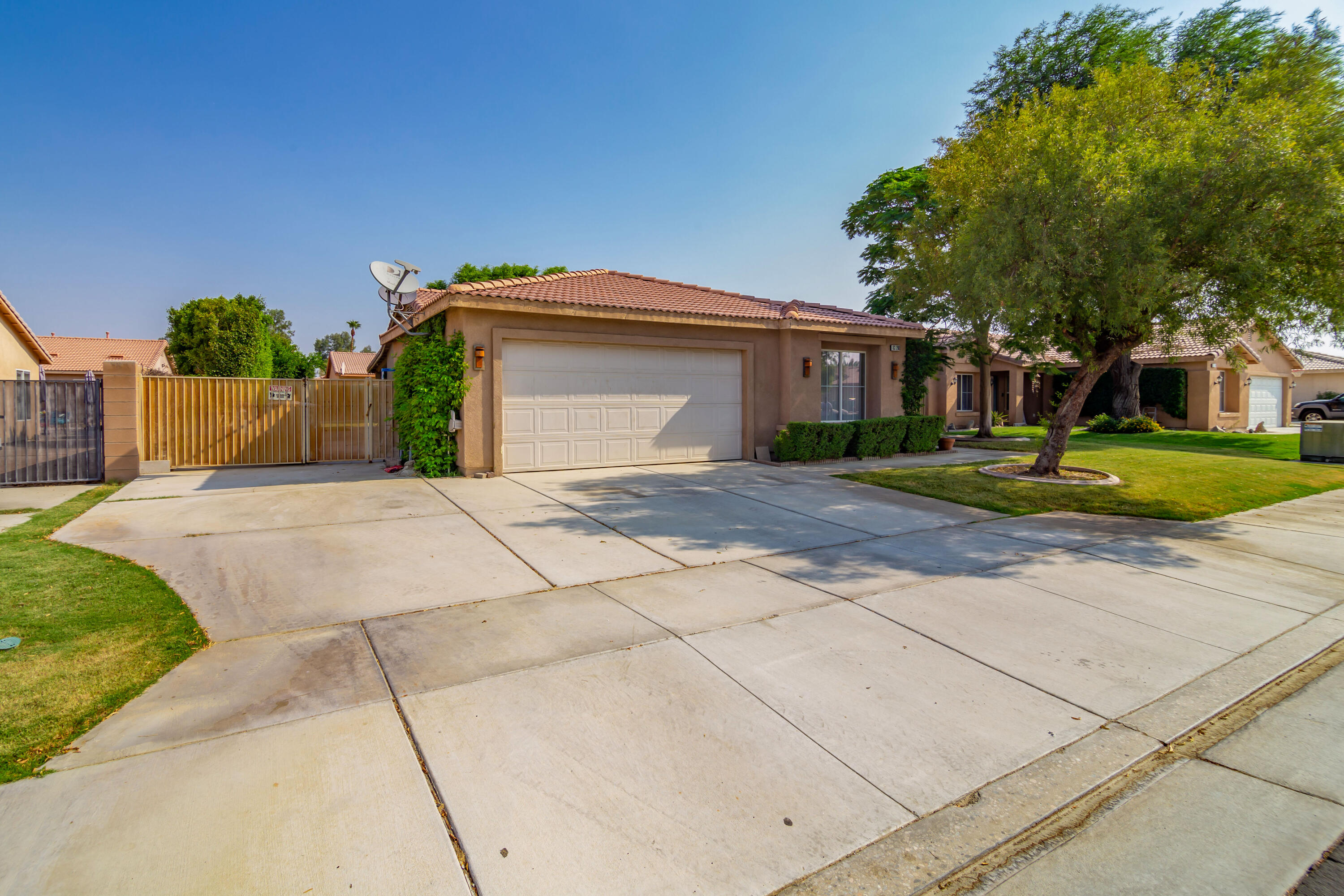83290 Antigua Drive Indio, CA 92201 - Photo 3 of 31 a front view of a house with garden