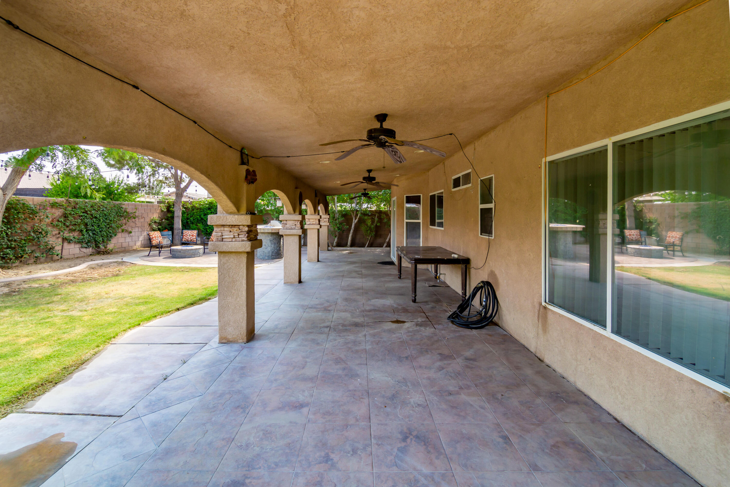 83290 Antigua Drive Indio, CA 92201 - Photo 24 of 31 a view of a swimming pool with a bench and floor to ceiling window