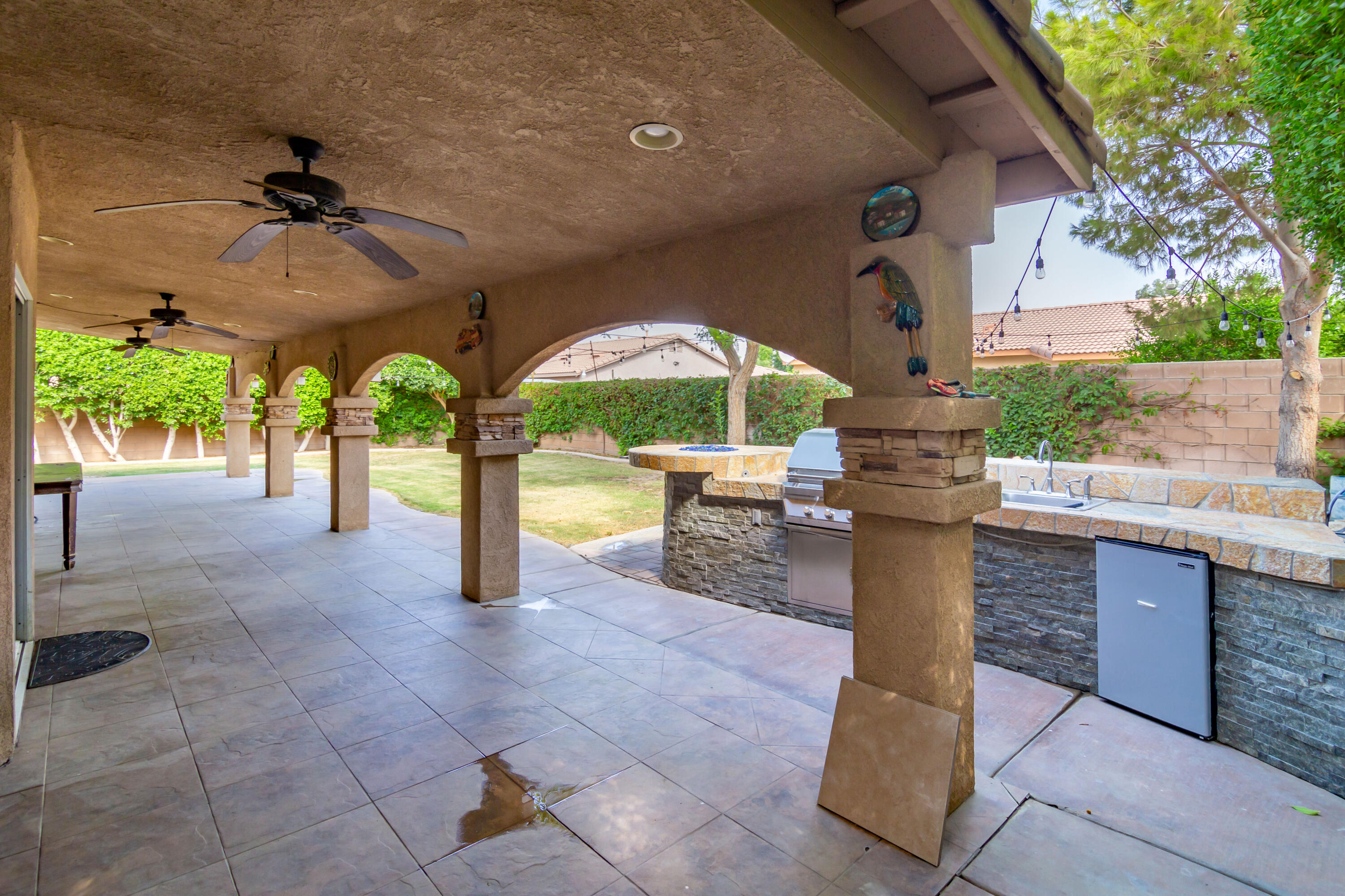 83290 Antigua Drive Indio, CA 92201 - Photo 25 of 31 a patio with a bench and sink