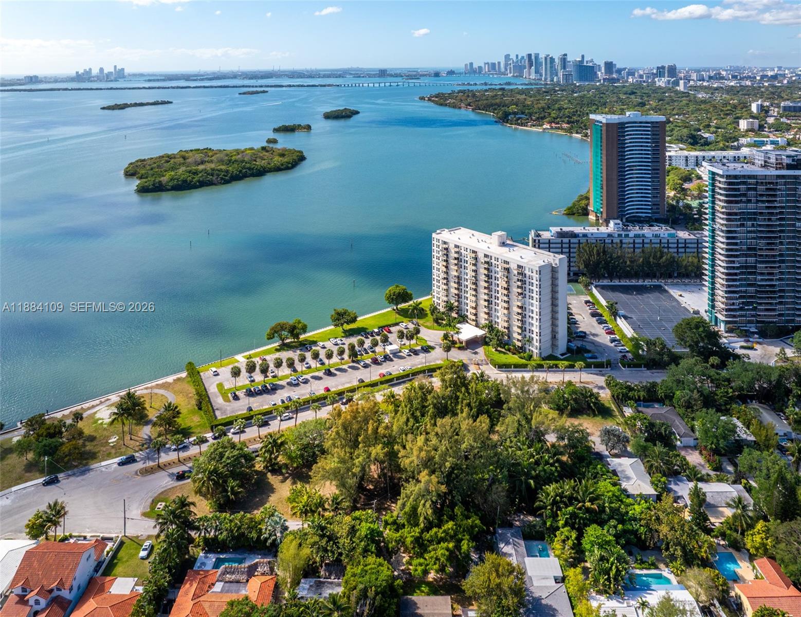 891 Northeast 70th Street Miami, FL 33138 - Photo 4 of 10 a roof deck with outdoor seating and lake view
