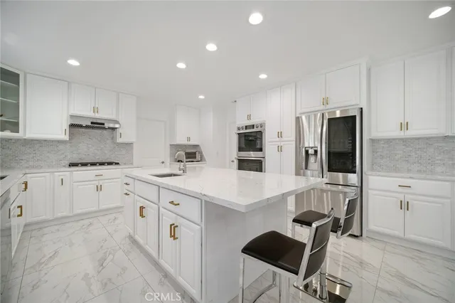 a kitchen with granite countertop a sink stove and cabinets