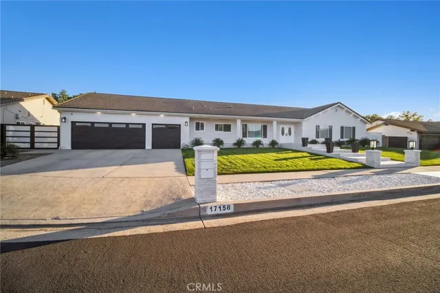 a view of swimming pool with outdoor seating and house in the background
