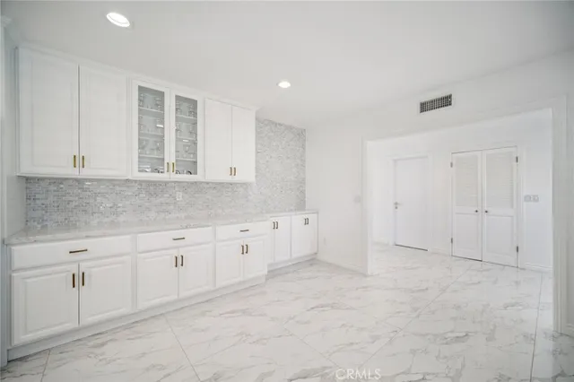 a bathroom with a sink and mirror with toilet