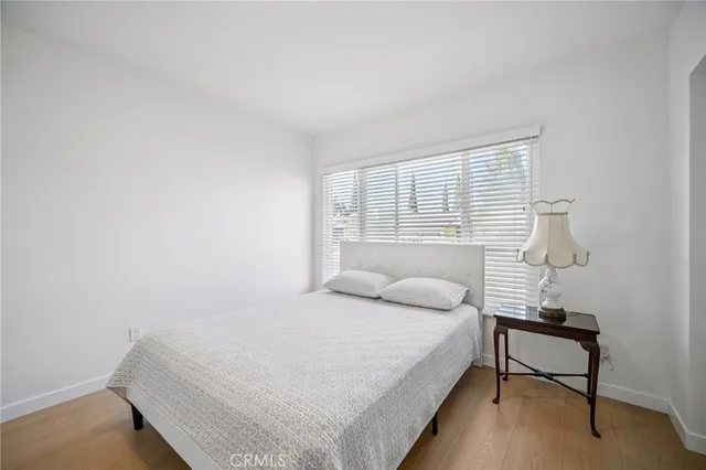 a bedroom with a bed and a night stand