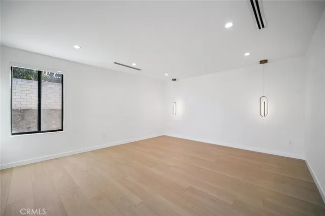 a front view of a house with a garden and yard