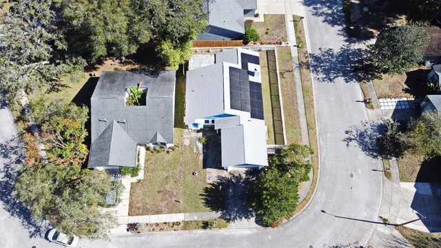 an aerial view of a residential apartment building with a yard and table and chairs plants