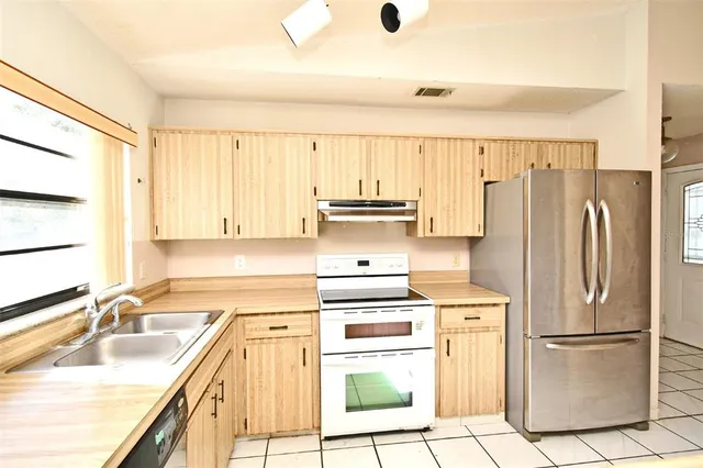 a kitchen with appliances cabinets and a sink