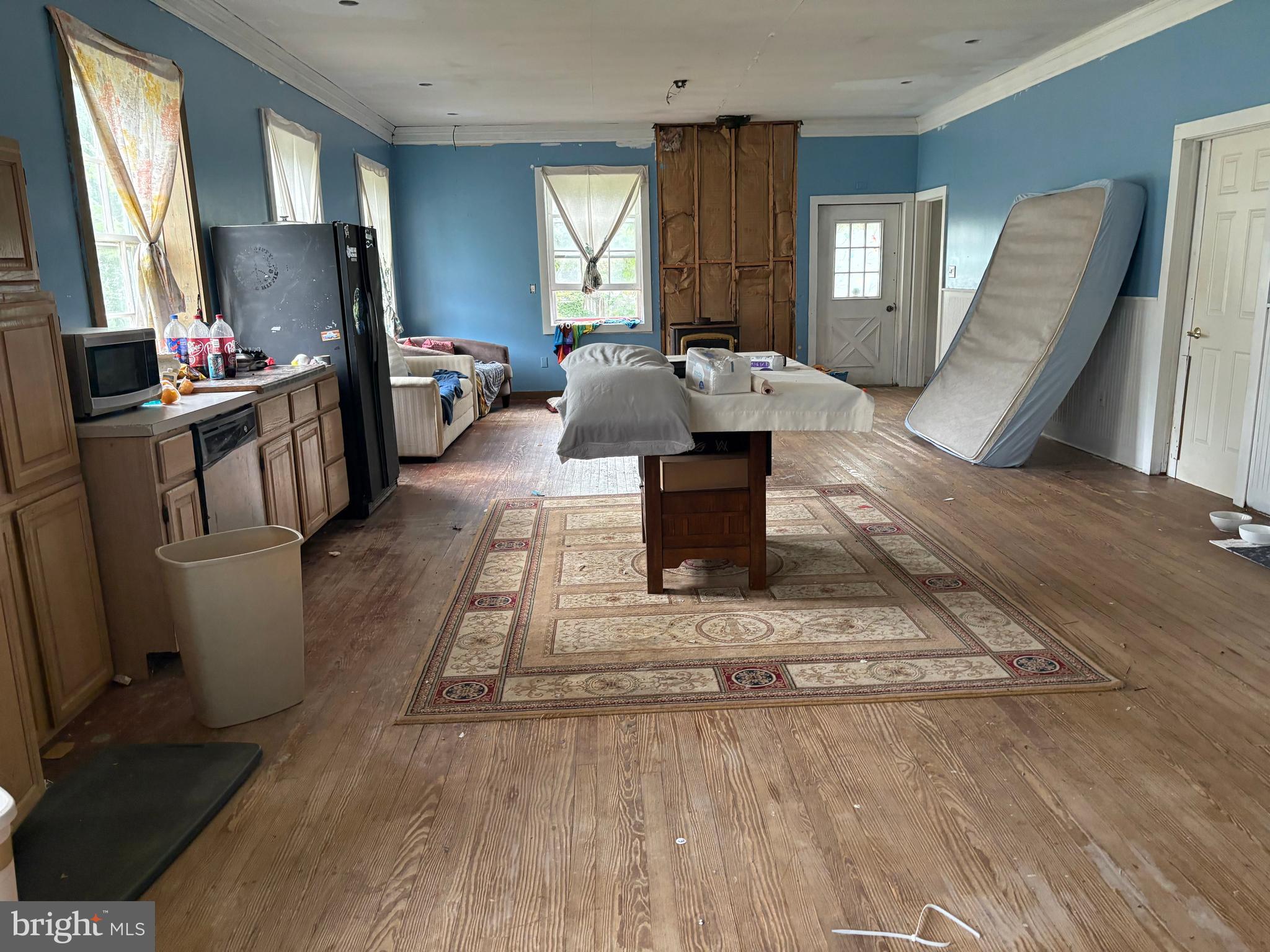 309 South Main Street Hurlock, MD 21643 - Photo 20 of 53 a living room with furniture a large window wooden floor and a flat screen tv