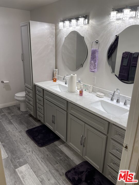 a bathroom with a double vanity sink and a mirror
