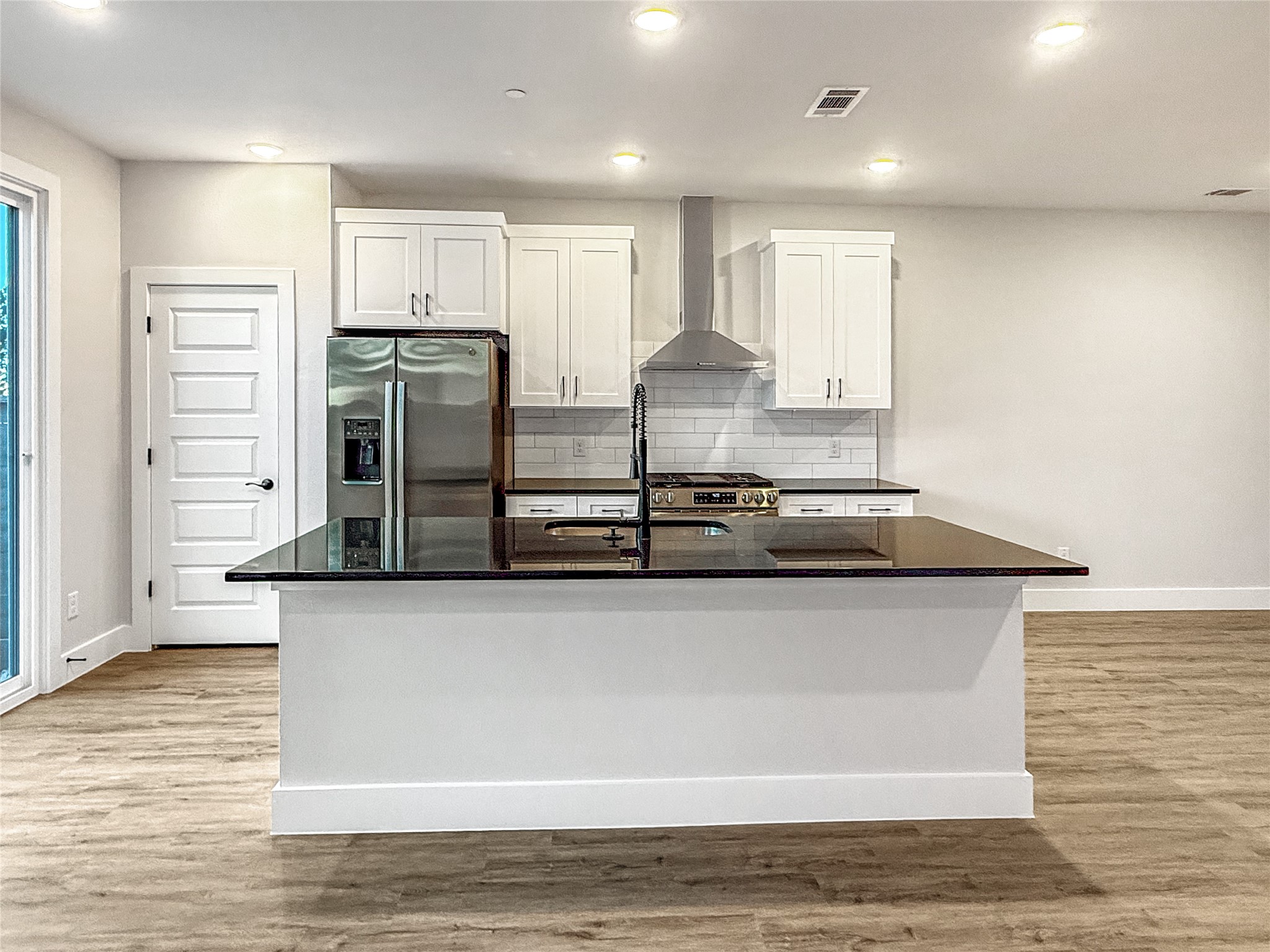 5611 Mobeetie Loop Bee Cave, TX 78738 - Photo 7 of 22 a kitchen with stainless steel appliances granite countertop a sink and a stove