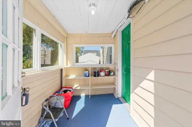 a bedroom with furniture and a large window