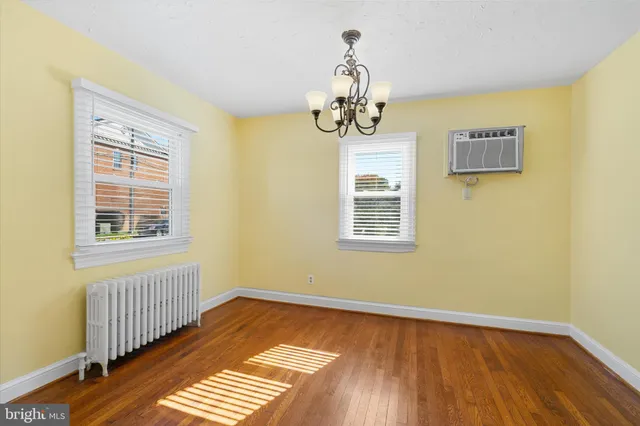 a view of a room with wooden floor and window