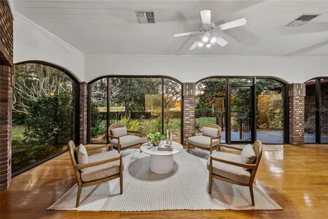 a view of a dining room with furniture wooden floor a livingroom and chandelier