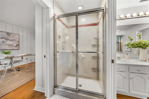 a bedroom with a bed and a painting on the wall