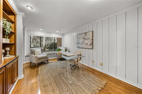 a view of a garden with plants and a large tree