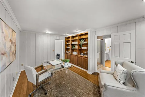 a front view of a house with a garden and sitting area