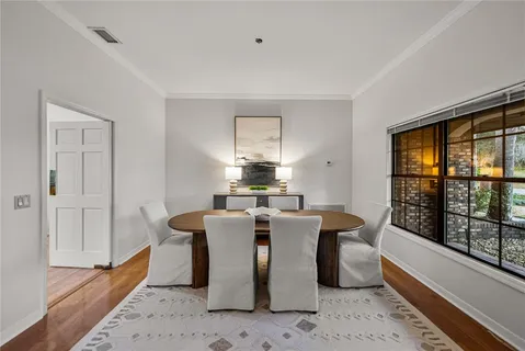 a view of a dining room with furniture window and wooden floor