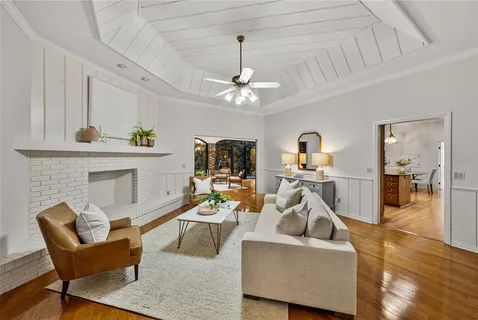 a living room with furniture and view of kitchen