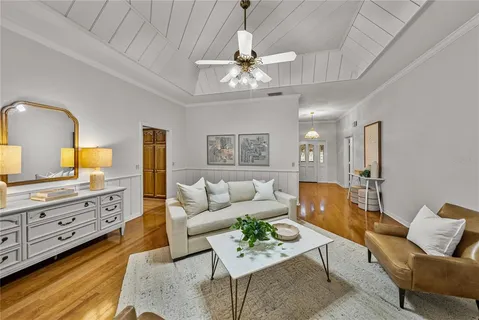 a living room with furniture and a chandelier