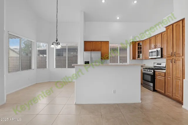 a large white kitchen with a large window