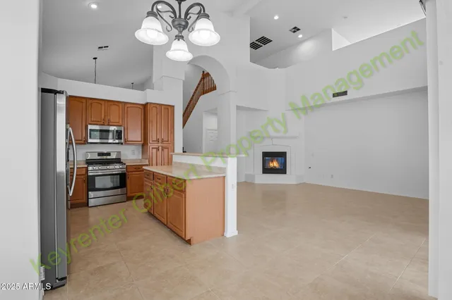 a view of kitchen with stainless steel appliances granite countertop a stove top oven a refrigerator a sink and dishwasher