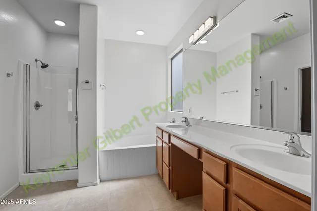 a view of an empty room with wooden floor and windows