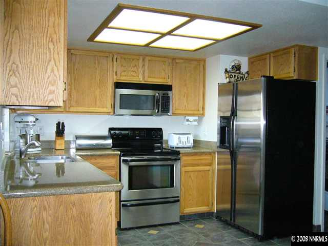 2742 Azuza Way Reno, NV 89502 - Photo 4 of 9 a kitchen with a refrigerator stove and microwave