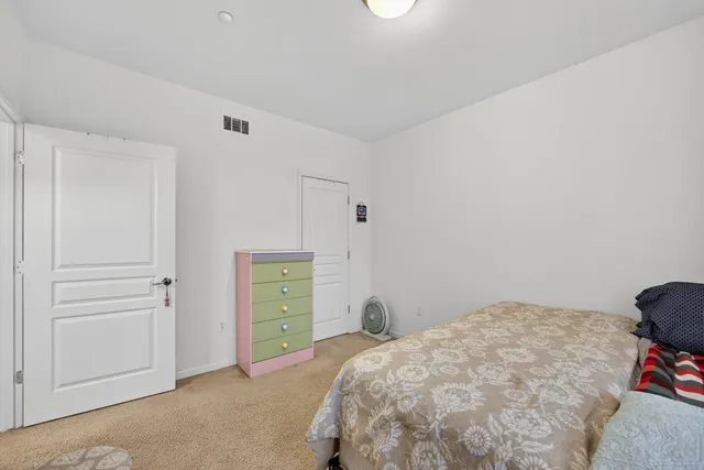 a bedroom with a bed and a closet