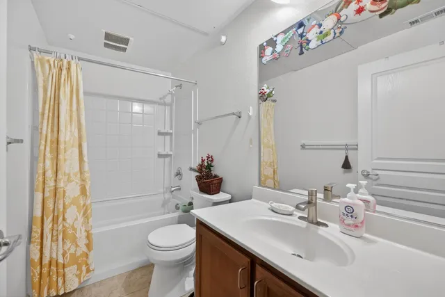 a bathroom with a sink vanity mirror and toilet