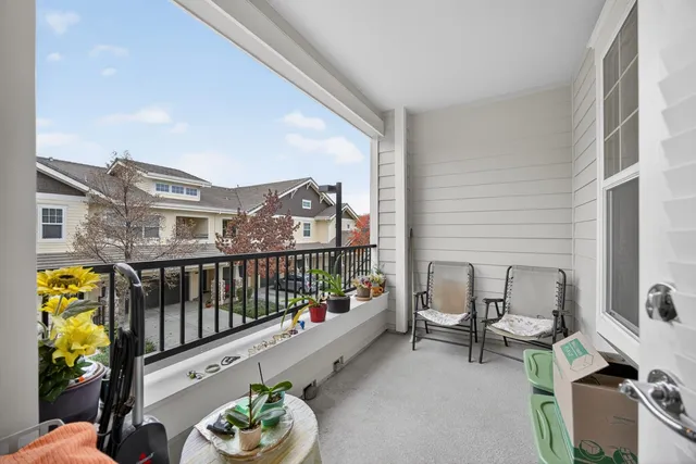 a balcony with furniture and wooden floor