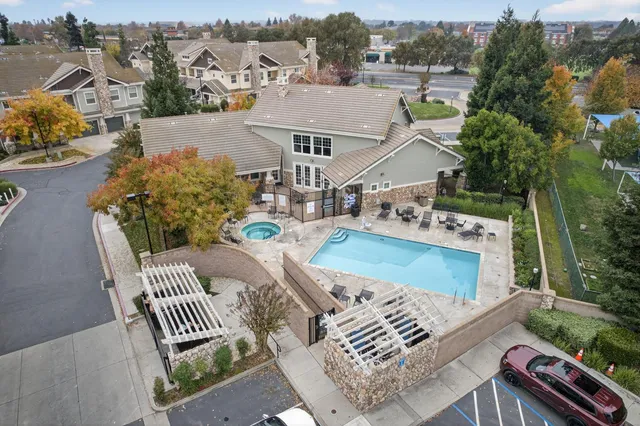 an aerial view of a house with a yard