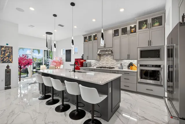 a living room with furniture and dining table with kitchen view