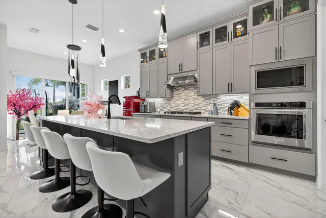 a living room with furniture flowers and a large window