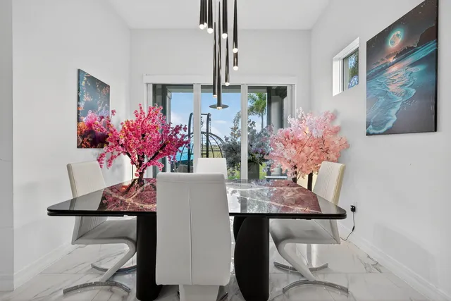 a living room with furniture kitchen view and a large window