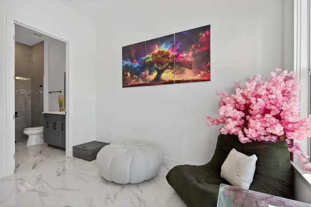an aerial view of a swimming pool with a yard and plants