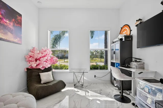 a living room with furniture a table and large windows