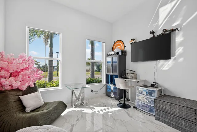 a room with stainless steel appliances kitchen island granite countertop furniture and a potted plant