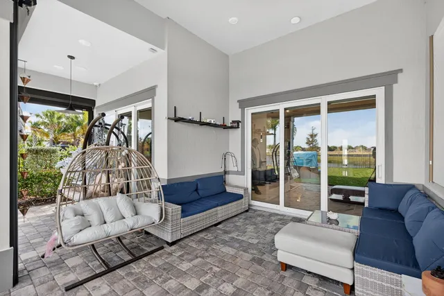 a view of a dining room with furniture large windows and wooden floor
