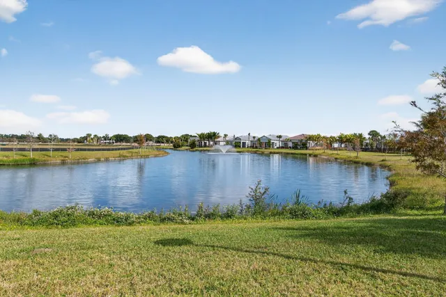 a kitchen with granite countertop a sink and a refrigerator